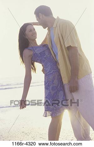people, couple, beach, romantic, romance, brunette, clothed View Large Photo Image Stock Image - people, couple, beach, romantic, romance, brunette, clothed. Fotosearch