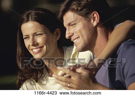 Stock Image - people, couple, outdoors, brunette, headshot, Caucasian, young adult. Fotosearch