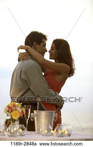 Stock Image - people, couple, outdoors, romantic, embracing, romance, candles. Fotosearch