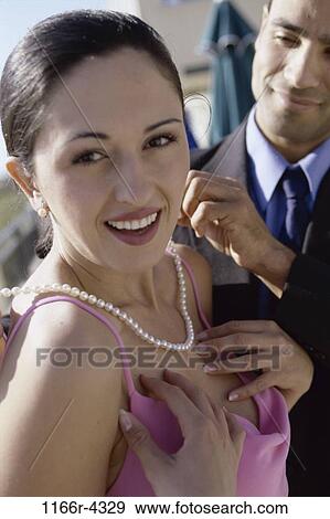 Stock Photo - people, couple, pearls, outdoors, necklace, gift, indulgence. Fotosearch