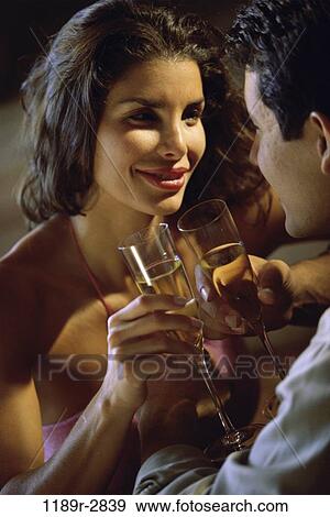 Stock Photo - people, couple, toasting, wine, Hispanic, drinking, toast. Fotosearch