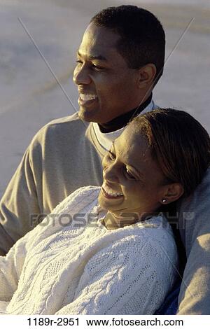 Stock Image - people, couple, watch, beach, watching, clothed, sweaters. Fotosearch
