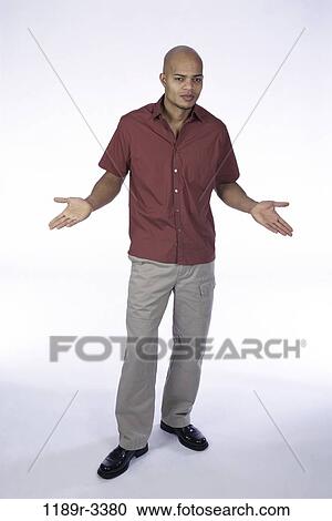 Stock Image - people, curious, indoors, African-American, shrug. Fotosearch