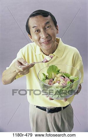 Stock Photo - people, eating, Asian, healthy, salad, bowl. Fotosearch