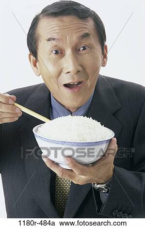 Stock Image - people, eating, Asian, healthy, chopsticks, bowl. Fotosearch