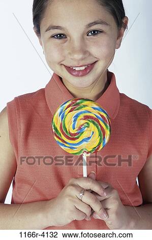 people, eating, candy, holding, girl, child, brunette View Large Photo Image Stock Image - people, eating, candy, holding, girl, child, brunette. Fotosearch