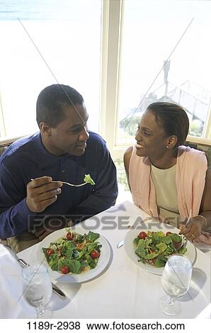 Stock Photo - people, eating, couple, healthy, Middle-aged, indoors, dining. Fotosearch