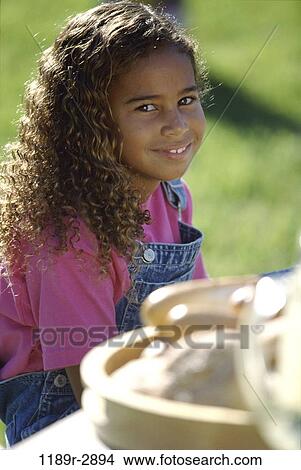 Picture - people, eating, girl, outdoors, child, food, anticipating. Fotosearch
