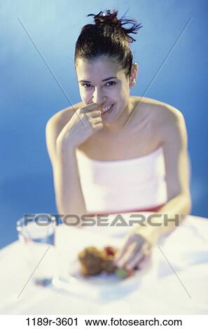 Stock Image - people, eating, glass, water, woman, table, sitting. Fotosearch