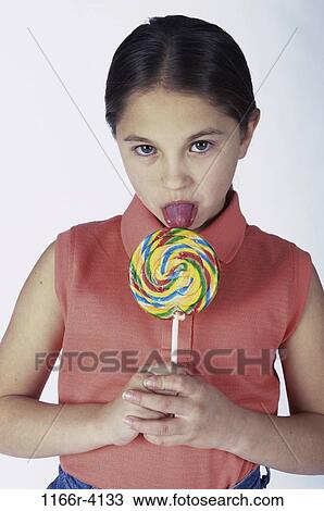 7 784 woman licking lollipop stock photos, vectors, and illustrations are available royalty-free.