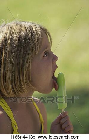 Stock Image - people, eating, licking, girl, outdoors, child, blond. Fotosearch