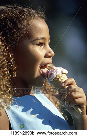 Stock Image - people, eating, profile, ice cream, girl, outdoors, child. Fotosearch