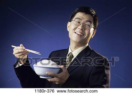 Stock Photograph - people, eating, smiling, Asian, eyeglasses. Fotosearch