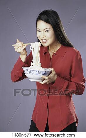 people, eating, woman, Asian, chopsticks, bowl, holding View Large Photo Image Stock Photo - people, eating, woman, Asian, chopsticks, bowl, holding. Fotosearch