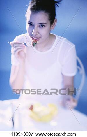 Stock Photo - people, eating, woman, Hispanic, fork, fruit, strawberry. Fotosearch