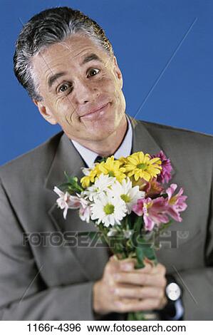 Stock Photograph - people, flowers, Middle-aged, romance, brunette, indoors. Fotosearch