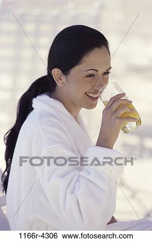 Stock Photograph - people, glass, woman, morning, Hispanic, healthy, orange. Fotosearch