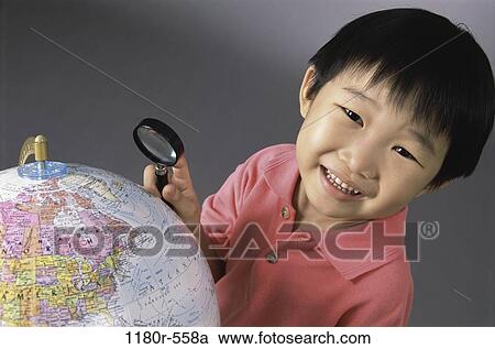 Stock Image - people, globe, Asian, boy, looking, child, education. Fotosearch