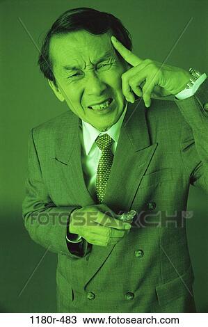 Stock Image - people, green, headache, Asian, senior, temple. Fotosearch