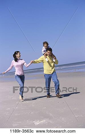 Stock Image - people, hands, walking, Hispanic, beach, holding, carrying. Fotosearch