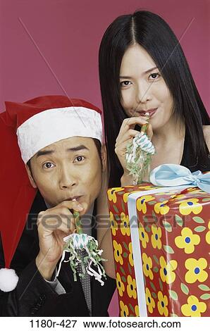 people, hat, celebration, Asian, couple, Christmas, gift View Large Photo Image Stock Photo - people, hat, celebration, Asian, couple, Christmas, gift. Fotosearch