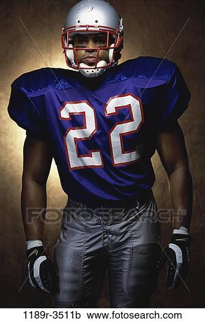 Stock Image - people, helmet, football, Middle-aged, portrait, indoors. Fotosearch