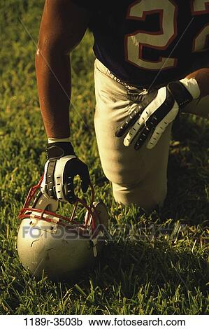 people, helmet, football, outdoors, kneeling, player View Large Photo Image Stock Image - people, helmet, football, outdoors, kneeling, player. Fotosearch