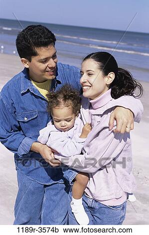Stock Image - people, Hispanic, beach, hugging, carrying, family, hug. Fotosearch