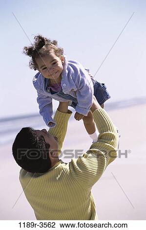 people, Hispanic, beach, lifting, family, father, daughter View Large Photo Image Stock Image - people, Hispanic, beach, lifting, family, father, daughter. Fotosearch