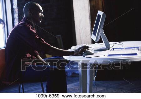 Stock Photo - people, home, computer, using, indoors, African-American. Fotosearch