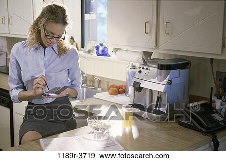 people, home, woman, eyeglasses, computer, breakfast, business View Large Photo Image Stock Photo - people, home, woman, eyeglasses, computer, breakfast, business. Fotosearch