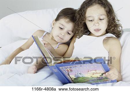 people, listening, reading, bed, book, family View Large Photo Image Stock Image - people, listening, reading, bed, book, family. Fotosearch