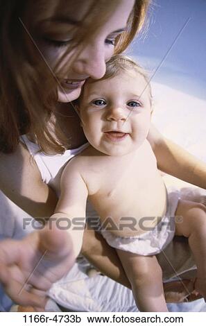 Stock Image - people, mother, baby, family, parent, indoors, Caucasian. Fotosearch