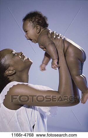 people, mother, baby, playful, family, brunette, parent View Large Photo Image Stock Photo - people, mother, baby, playful, family, brunette, parent. Fotosearch