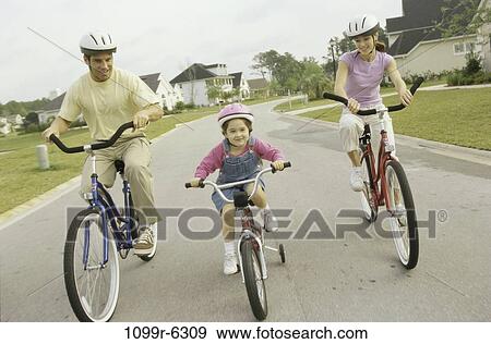 people, outdoors, bicycles, family, daughter, helmets View Large Photo Image Stock Photo - people, outdoors, bicycles, family, daughter, helmets. Fotosearch