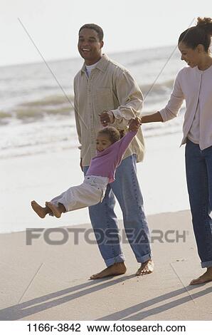 people, playing, beach, swinging, swing, playful, waves View Large Photo Image Stock Image - people, playing, beach, swinging, swing, playful, waves. Fotosearch