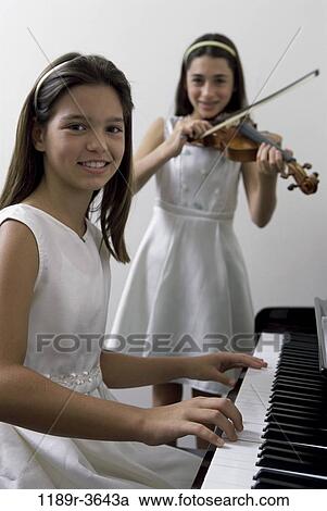 Stock Image - people, playing, piano, violin, children, play, girls. Fotosearch