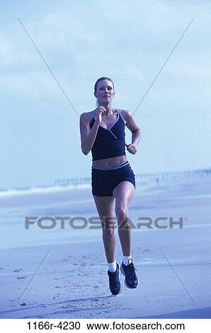 Stock Image - people, running, woman, beach, Caucasian, run, young adult. Fotosearch