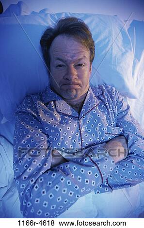 Stock Photo - people, sleeping, bed, Middle-aged, angry, pouting. Fotosearch