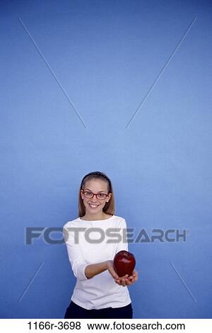 people, smiling, eyeglasses, apple, fruit, holding, girl View Large Photo Image Stock Photo - people, smiling, eyeglasses, apple, fruit, holding, girl. Fotosearch