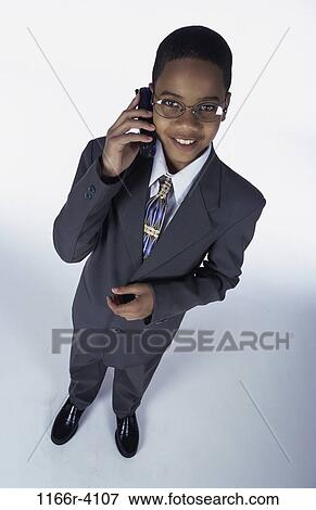 Stock Photo - people, suit, talking, eyeglasses, phone, boy, costume. Fotosearch