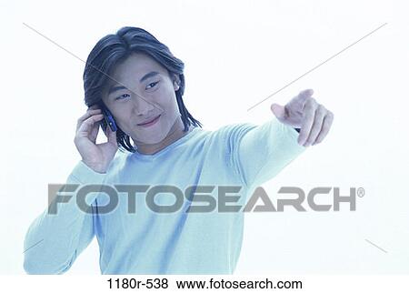 Stock Photo - people, telephone, talking, Asian, phone, pointing. Fotosearch