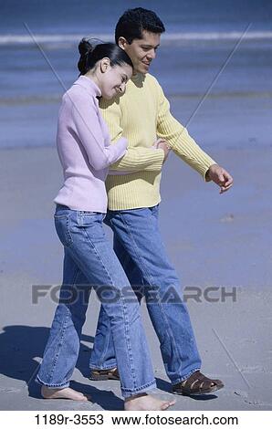people, walking, couple, beach, jeans, clothed, sweaters View Large Photo Image Stock Image - people, walking, couple, beach, jeans, clothed, sweaters. Fotosearch