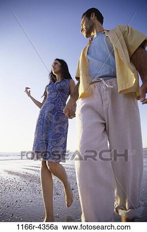 people, walking, couple, beach, brunette, clothed, walk View Large Photo Image Stock Image - people, walking, couple, beach, brunette, clothed, walk. Fotosearch