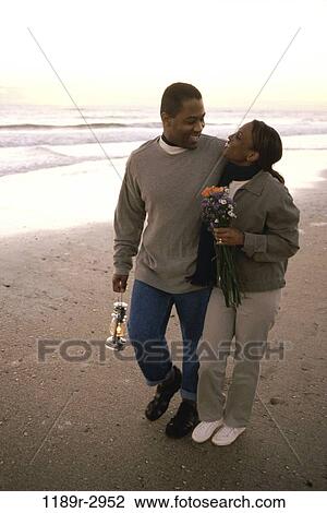 people, walking, couple, beach, sweater, flowers, romantic View Large Photo Image Stock Image - people, walking, couple, beach, sweater, flowers, romantic. Fotosearch