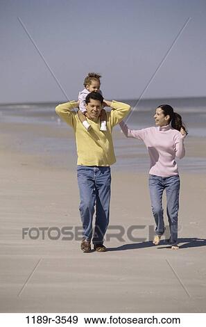 people, walking, Hispanic, beach, carrying, family, daughter View Large Photo Image Stock Photo - people, walking, Hispanic, beach, carrying, family, daughter. Fotosearch