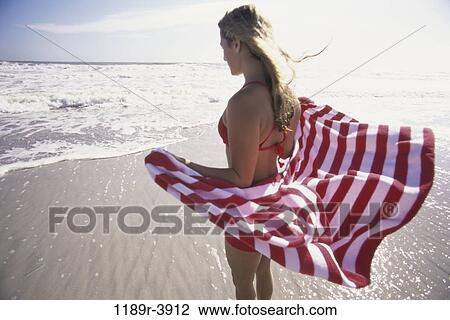 people, water, woman, windy, beach, standing View Large Photo Image Stock Image - people, water, woman, windy, beach, standing. Fotosearch