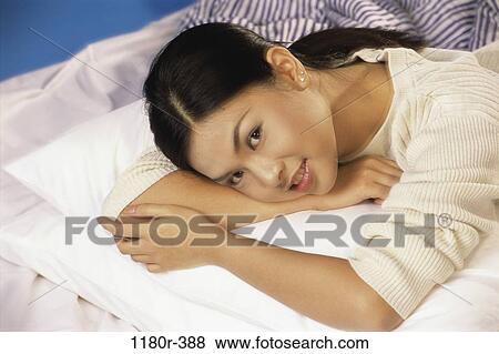 people, woman, Asian, bed, laying, indoors, lay View Large Photo Image Stock Photo - people, woman, Asian, bed, laying, indoors, lay. Fotosearch