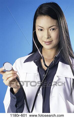 Stock Image - people, woman, Asian, listening, doctor, stethoscope, medicine. Fotosearch
