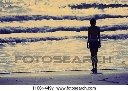 Stock Photo - people, woman, beach, silhouette, contemplating, contemplate, young adult. Fotosearch